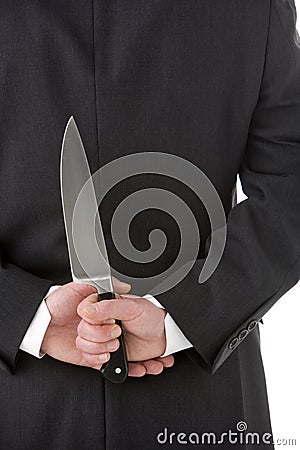 Businessman Holding Knife Behind His Back Stock Photo