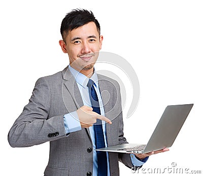 Businessman holding laptop and finger pointing to screen Stock Photo