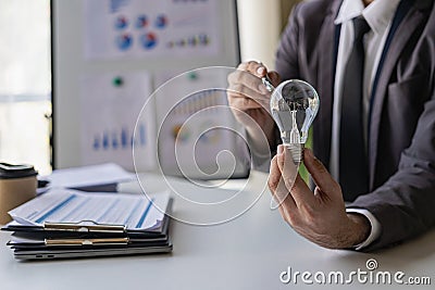 businessman holding a light bulb in hand banner Successful and creative business concept closes up Stock Photo