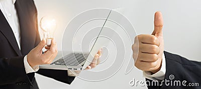 Businessman holding light bulb and laptop, energy saving concept, white background Stock Photo
