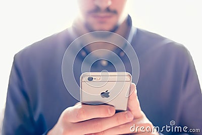 Businessman holding the new Apple iPhone 6s retina Editorial Stock Photo