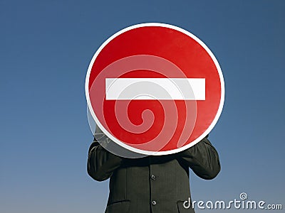 Businessman Holding 'No Entry' Sign In Front Of Face Stock Photo