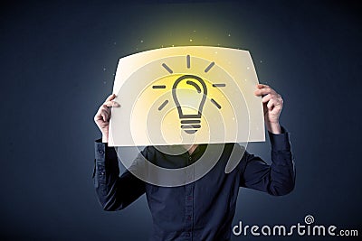 Businessman holding paper with lightbulb Stock Photo