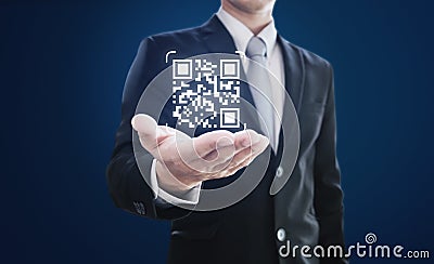 Businessman holding QR code on hand. QR code scanning payment and verification technology Stock Photo