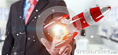 Businessman holding red rocket in his hand 3D rendering Stock Photo