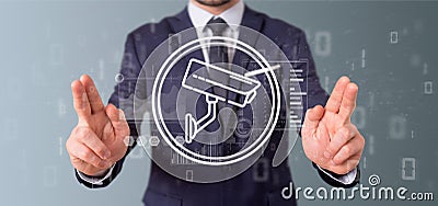 Businessman holding Security camera system icon and statistics d Stock Photo