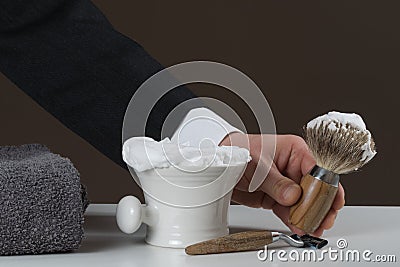 Businessman is holding Shaving Equipment in his Hand Stock Photo
