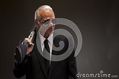 Businessman holding shotgun Stock Photo