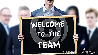 Businessman holding sign with words Welcome To The Team Stock Photo