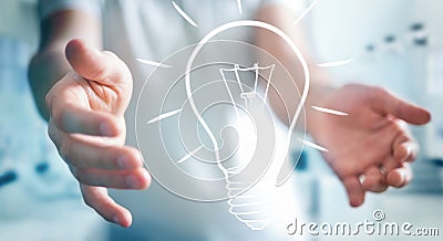 Businessman holding a sketch lightbulb Stock Photo