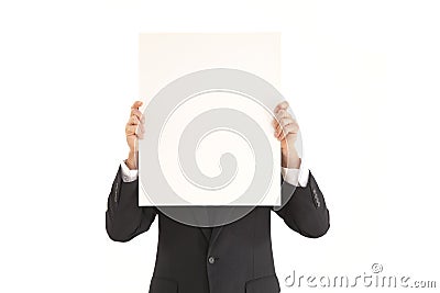 Businessman holding up blank poster Stock Photo