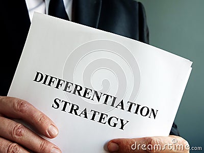 Businessman holds differentiation strategy. Stock Photo