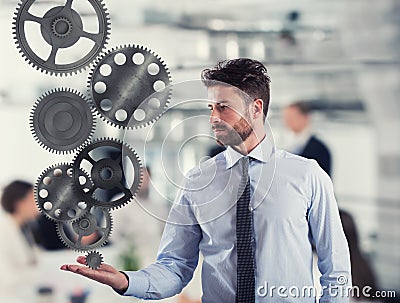 Businessman holds a gear system. Concept of business mechanism Stock Photo