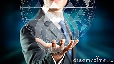 Businessman holding a holographic globe over his hand Stock Photo