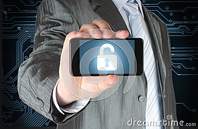 Businessman holds smart phone with open lock Stock Photo