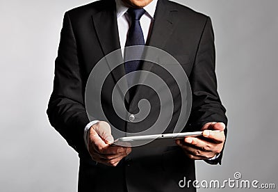 Businessman holds a table pc Stock Photo