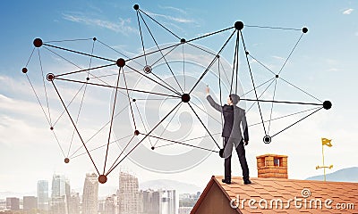 Businessman on house roof presenting networking and connection c Stock Photo