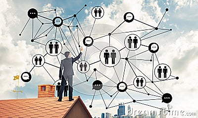 Businessman on house roof presenting networking and connection c Stock Photo