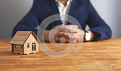 Businessman house on wooden background Stock Photo