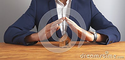 Businessman house on wooden background Stock Photo