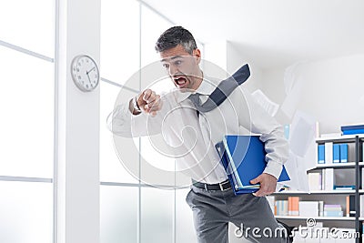 Businessman in a hurry checking time Stock Photo