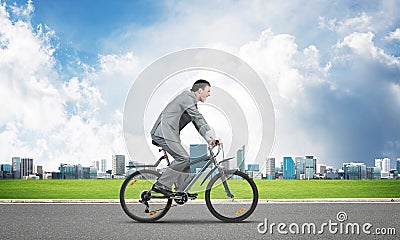 Businessman hurry to work by bike Stock Photo