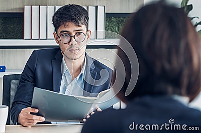 Businessman interview with interviewer candidate see qualification data that apply for job at meeting room in modern office Stock Photo