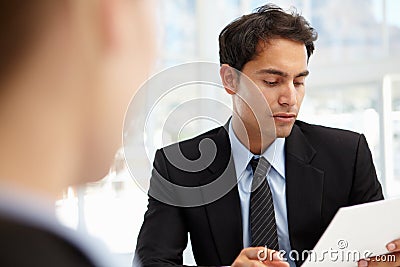 Businessman interviewing female employee Stock Photo