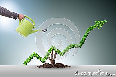 The businessman in investment concept watering financial line chart Stock Photo