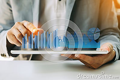Businessman investor analyzing company financial mutual fund report working with digital augmented reality graphics technology. Co Stock Photo