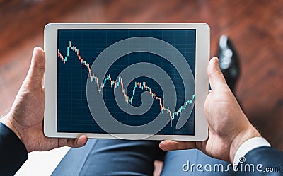 Businessman, investor,trader analyzing,looking at chart of stock prices in tablet. CEO,general manager.Bank investment.Finance Stock Photo
