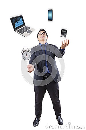Businessman juggling with business items Stock Photo