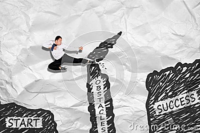 Businessman jumping and destroy obstacle Stock Photo