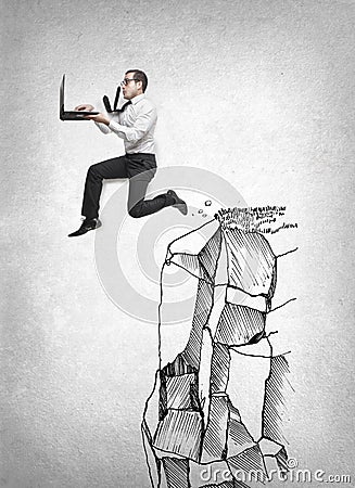 Businessman jumping with his laptop Stock Photo