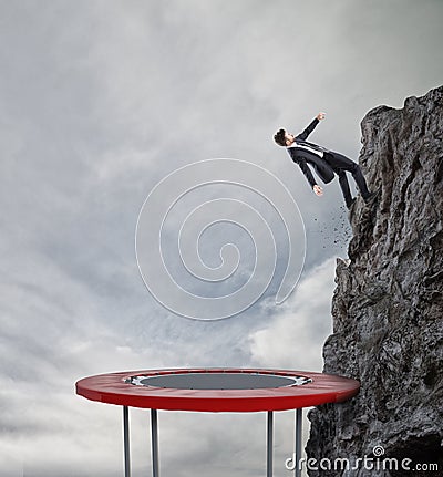 Businessman jumping on a trampoline to reach the flag. Achievement business goal and Difficult career concept Stock Photo