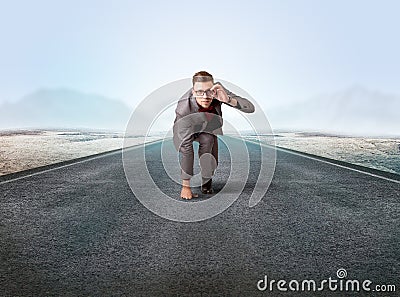 Businessman kneeling in ready position Stock Photo