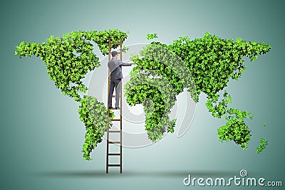 The businessman on ladder in green environment concept Stock Photo