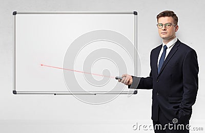 Businessman with laser pointer and copyspace white blackboard Stock Photo