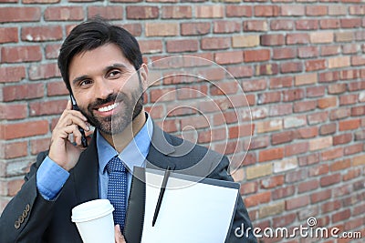 Businessman laughing over a joke on phone call Stock Photo