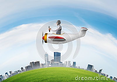 Businessman in leather helmet flying in plane Stock Photo