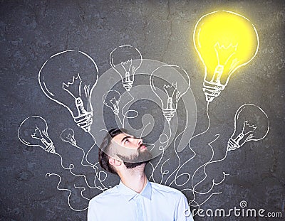 Businessman with lighbulb drawings Stock Photo