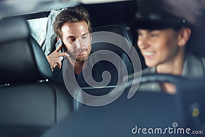 Businessman in limousine chauffeur driving Stock Photo