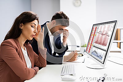 Businessman Looking At Audit Data And Financial Loss Stock Photo