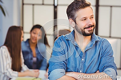 Businessman looking away against female coworkers Stock Photo