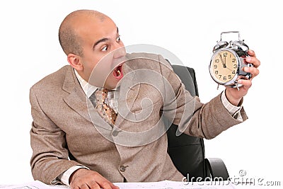 Businessman looking at clock alarm Stock Photo