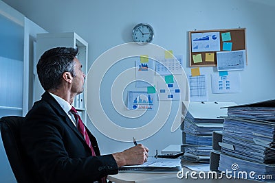 Businessman looking at clock Stock Photo