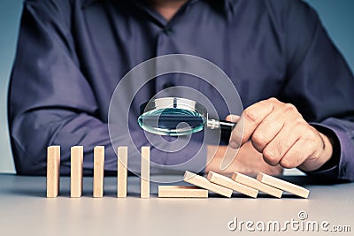 Businessman looking the falling domino Stock Photo