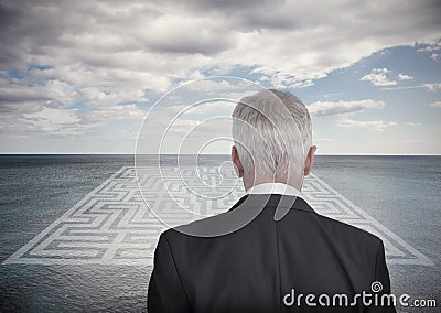 Businessman looking at landscape and maze Stock Photo