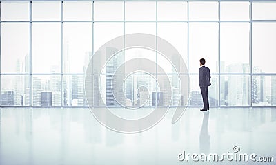 Businessman looking at megalopolis through window Stock Photo