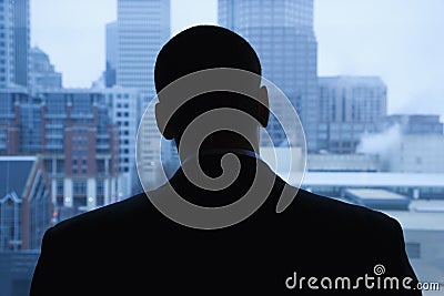 Businessman Looking Out of Window Stock Photo